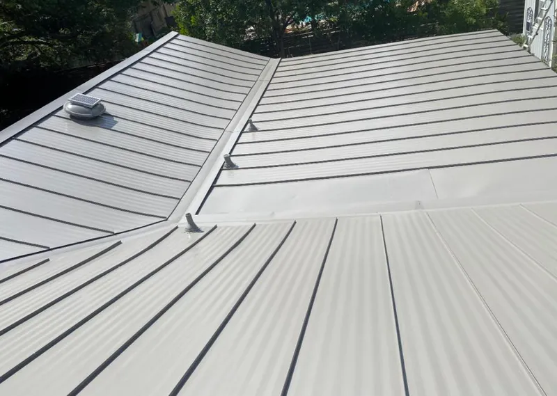 Solar attic fan installed on a metal roof for Roof Ventilation in Hapeville